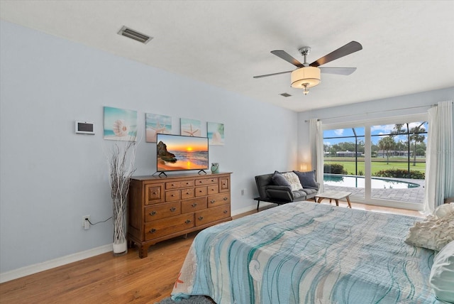 538 Magellan Dr, Sarasota, FL 34243 - bedroom with access to outside, wood finished floors, and a ceiling fan