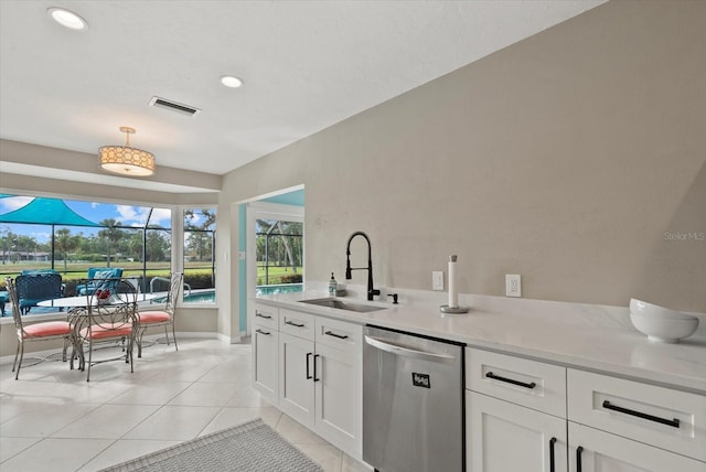 538 Magellan Dr, Sarasota, FL 34243 - kitchen featuring dishwasher, light tile patterned flooring, white cabinetry, hanging light fixtures, and recessed lighting