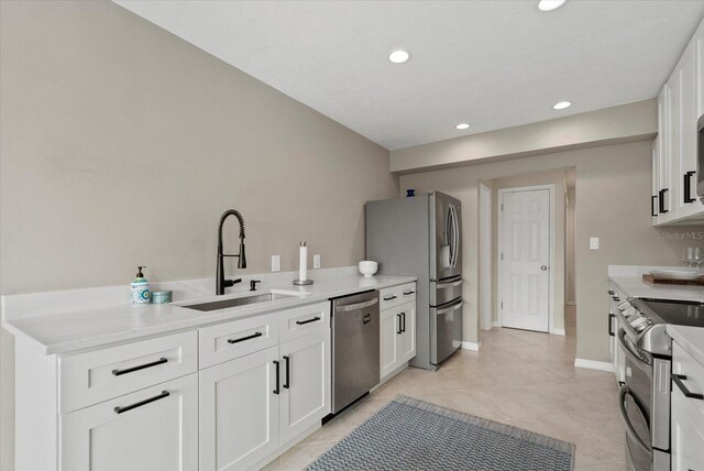 538 Magellan Dr, Sarasota, FL 34243 - kitchen featuring stainless steel appliances, white cabinets, light countertops, recessed lighting, and light tile patterned floors
