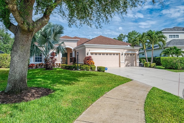 6610 Rosy Barb Ct, Lakewood Ranch, FL 34202 - view of front of property with stucco siding, a front yard, concrete driveway, and a garage