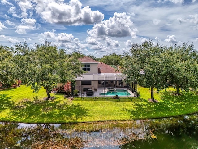6610 Rosy Barb Ct, Lakewood Ranch, FL 34202 - rear view of house featuring an outdoor pool, a water view, a lawn, a patio area, and stucco siding
