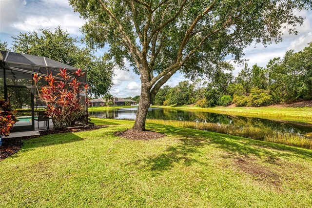 6610 Rosy Barb Ct, Lakewood Ranch, FL 34202 - view of grassy yard with a water view, an outdoor pool, and a lanai