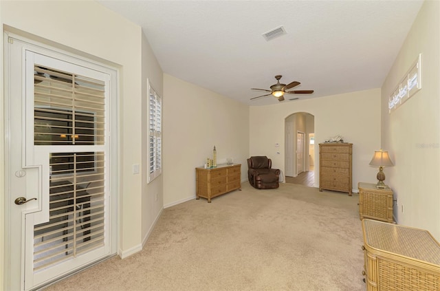 6610 Rosy Barb Ct, Lakewood Ranch, FL 34202 - living area with arched walkways, light carpet, and ceiling fan