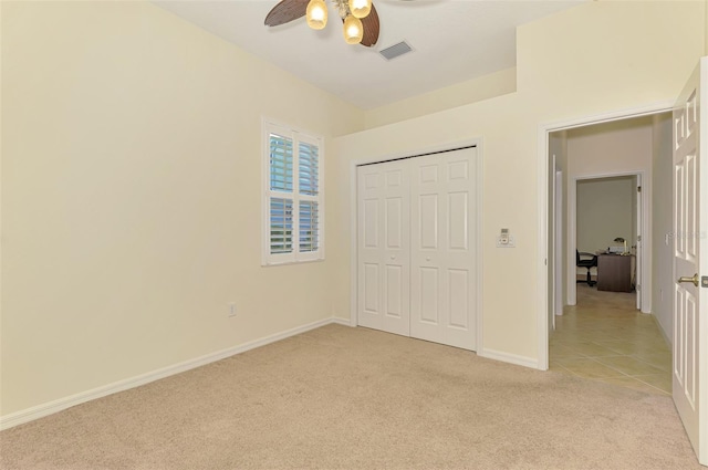 6610 Rosy Barb Ct, Lakewood Ranch, FL 34202 - unfurnished bedroom featuring light carpet, a closet, and a ceiling fan