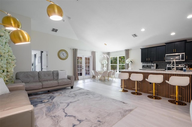 3524 Brownwood Ter, North Port, FL 34286 - living area with vaulted ceiling, light wood finished floors, and recessed lighting