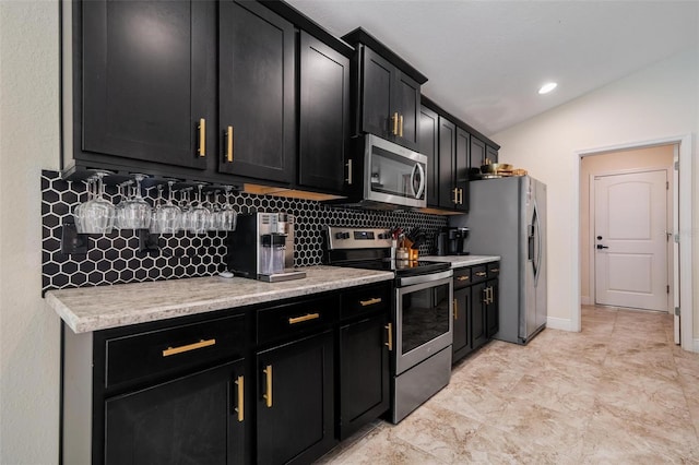 3524 Brownwood Ter, North Port, FL 34286 - kitchen featuring appliances with stainless steel finishes, dark cabinetry, backsplash, light countertops, and vaulted ceiling