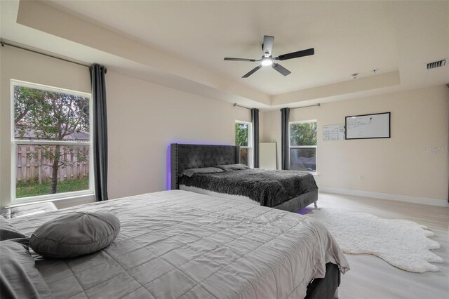 3524 Brownwood Ter, North Port, FL 34286 - bedroom with a raised ceiling, wood finished floors, and ceiling fan