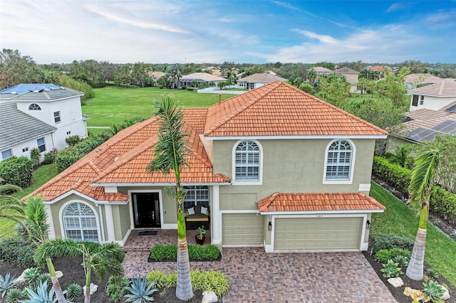 12814 Daisy Pl, Bradenton, FL 34212 - mediterranean / spanish house with stucco siding, a tile roof, an attached garage, and driveway
