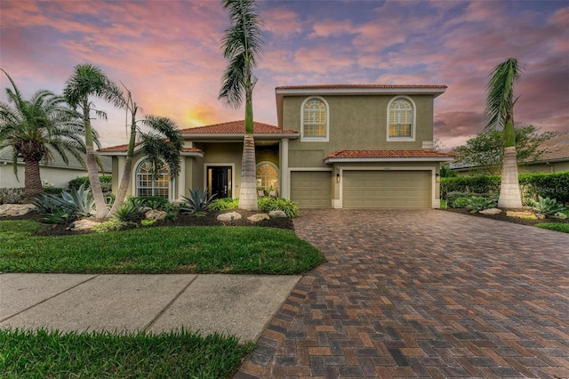 12814 Daisy Pl, Bradenton, FL 34212 - mediterranean / spanish house featuring an attached garage, stucco siding, driveway, and a tiled roof