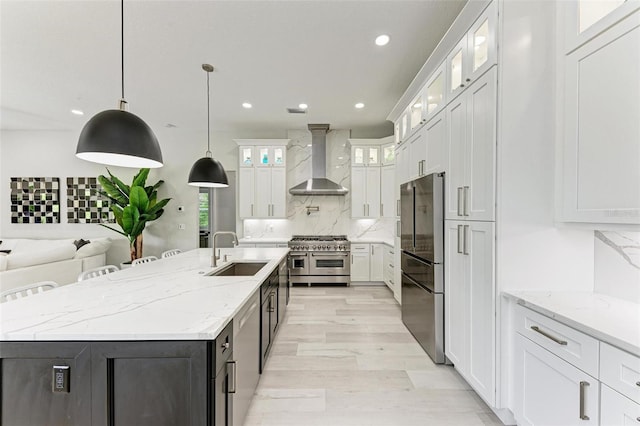 12814 Daisy Pl, Bradenton, FL 34212 - kitchen with wall chimney exhaust hood, stainless steel appliances, a kitchen island with sink, white cabinets, and recessed lighting