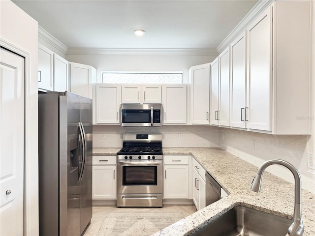 16087 Sunny Day Dr, Bradenton, FL 34211 - kitchen with appliances with stainless steel finishes, white cabinetry, crown molding, light stone counters, and decorative backsplash