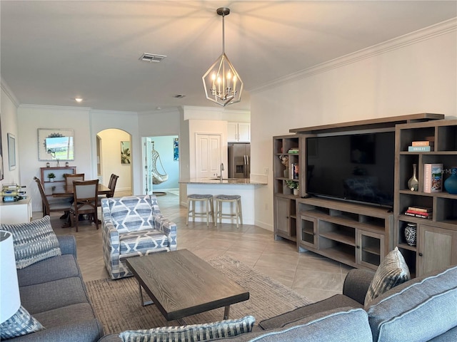 16087 Sunny Day Dr, Bradenton, FL 34211 - living area with a chandelier, arched walkways, crown molding, and light tile patterned floors