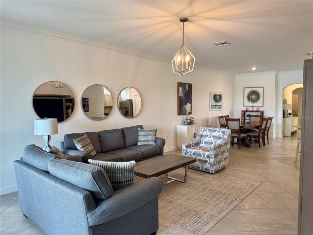 16087 Sunny Day Dr, Bradenton, FL 34211 - living room with arched walkways, a chandelier, ornamental molding, and light tile patterned floors