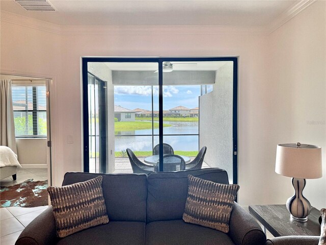 16087 Sunny Day Dr, Bradenton, FL 34211 - living room with tile patterned flooring, ornamental molding, and a water view