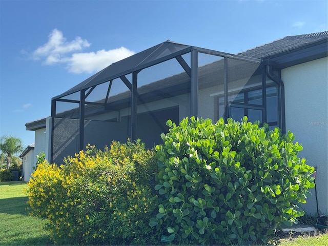 16087 Sunny Day Dr, Bradenton, FL 34211 - view of property exterior with stucco siding, a lanai, and a yard