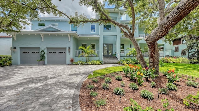 1076 Toc0Baga, Sarasota, FL 34234 - view of front of property featuring a porch, stucco siding, decorative driveway, and french doors