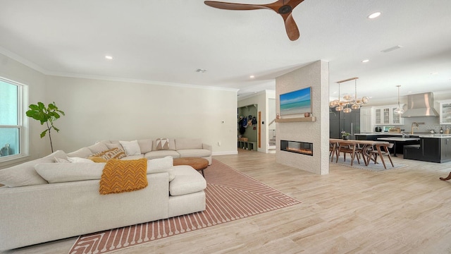 1076 Toc0Baga, Sarasota, FL 34234 - living area with light wood-style floors, ceiling fan, recessed lighting, a fireplace, and crown molding