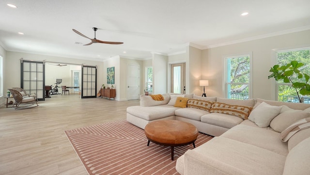 1076 Toc0Baga, Sarasota, FL 34234 - living room featuring a barn door, light wood-type flooring, recessed lighting, crown molding, and a ceiling fan