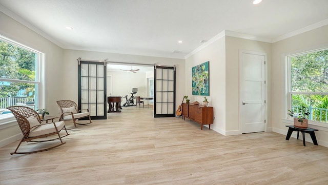 1076 Toc0Baga, Sarasota, FL 34234 - sitting room featuring plenty of natural light, light wood-type flooring, french doors, ornamental molding, and recessed lighting