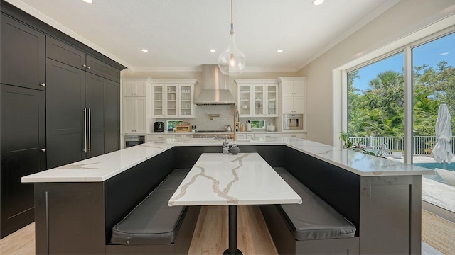 1076 Toc0Baga, Sarasota, FL 34234 - kitchen featuring wall chimney exhaust hood, crown molding, backsplash, recessed lighting, and a large island