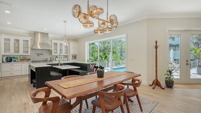 1076 Toc0Baga, Sarasota, FL 34234 - dining area with plenty of natural light, light wood-style floors, a chandelier, recessed lighting, and ornamental molding
