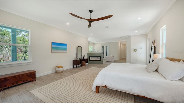 1076 Toc0Baga, Sarasota, FL 34234 - bedroom with light wood-style floors, recessed lighting, ornamental molding, a glass covered fireplace, and a ceiling fan