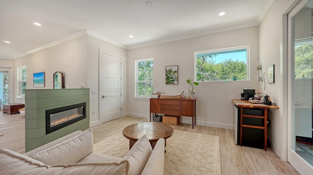 1076 Toc0Baga, Sarasota, FL 34234 - living area with plenty of natural light, light wood-type flooring, recessed lighting, a glass covered fireplace, and ornamental molding