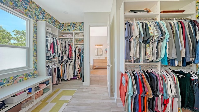 1076 Toc0Baga, Sarasota, FL 34234 - walk in closet with wood finished floors