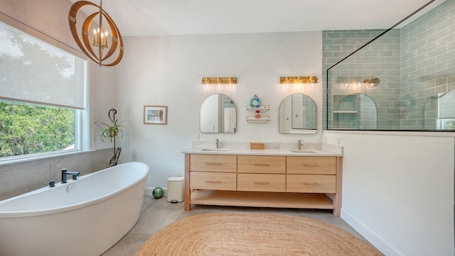 1076 Toc0Baga, Sarasota, FL 34234 - bathroom with double vanity, a freestanding tub, a tile shower, and tile patterned floors