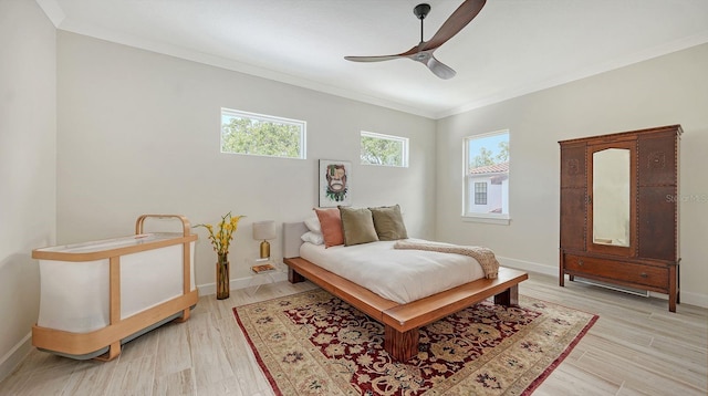 1076 Toc0Baga, Sarasota, FL 34234 - bedroom featuring multiple windows, ornamental molding, a ceiling fan, and light wood-type flooring
