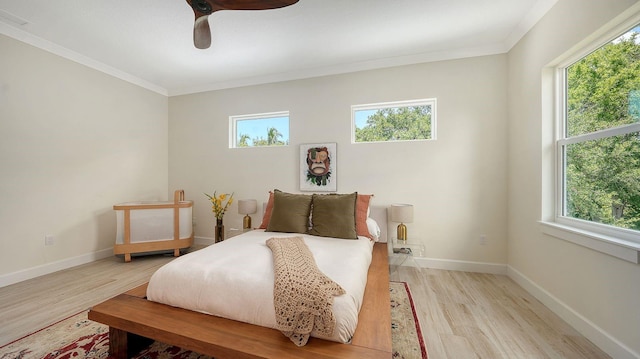 1076 Toc0Baga, Sarasota, FL 34234 - bedroom featuring light wood-style floors, multiple windows, crown molding, and a ceiling fan