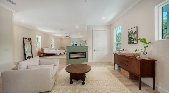 1076 Toc0Baga, Sarasota, FL 34234 - living room with plenty of natural light, light wood-type flooring, crown molding, recessed lighting, and a ceiling fan