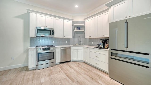 1076 Toc0Baga, Sarasota, FL 34234 - kitchen featuring stainless steel appliances, light countertops, open shelves, tasteful backsplash, and recessed lighting