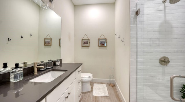 1076 Toc0Baga, Sarasota, FL 34234 - bathroom with vanity, a tile shower, and wood finished floors