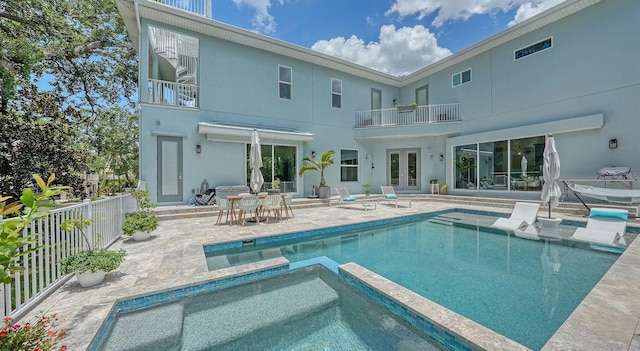 1076 Toc0Baga, Sarasota, FL 34234 - back of property featuring a balcony, a patio area, stucco siding, french doors, and a pool with connected hot tub