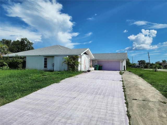 4354 Rock Creek Dr, Port Charlotte, FL 33948 - ranch-style home with driveway, an attached garage, stucco siding, and a front lawn
