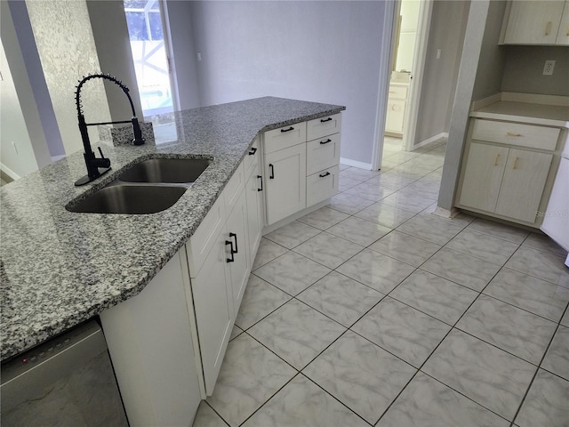 4354 Rock Creek Dr, Port Charlotte, FL 33948 - kitchen featuring dishwasher, light stone counters, white cabinetry, and light tile patterned floors