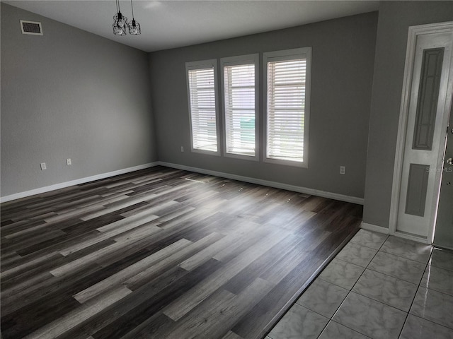 4354 Rock Creek Dr, Port Charlotte, FL 33948 - spare room with wood finished floors and a chandelier