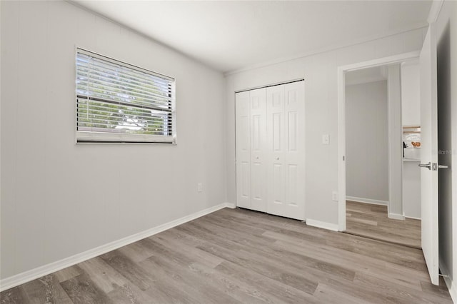 1008 37th St W, Bradenton, FL 34205 - unfurnished bedroom with wood finished floors and a closet
