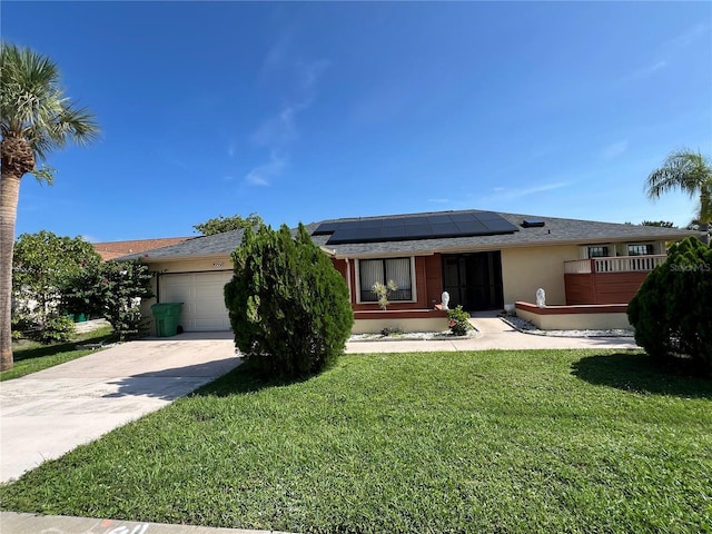 19358 Edgewater Dr, Port Charlotte, FL 33948 - view of front of home with a garage, roof mounted solar panels, concrete driveway, a front yard, and stucco siding