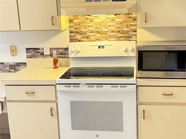 19358 Edgewater Dr, Port Charlotte, FL 33948 - kitchen featuring white range with electric stovetop, stainless steel microwave, extractor fan, and tasteful backsplash