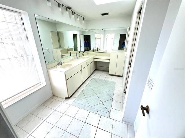 19358 Edgewater Dr, Port Charlotte, FL 33948 - bathroom with double vanity and baseboards