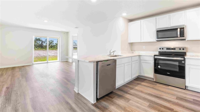 12039 Lansing Gln, Parrish, FL 34219 - kitchen featuring appliances with stainless steel finishes, light wood-style floors, light countertops, and recessed lighting