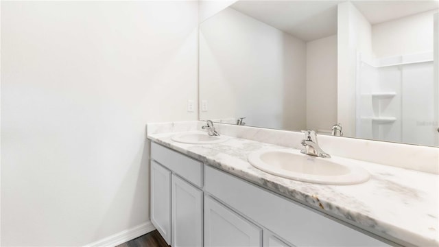 12039 Lansing Gln, Parrish, FL 34219 - bathroom featuring double vanity and baseboards
