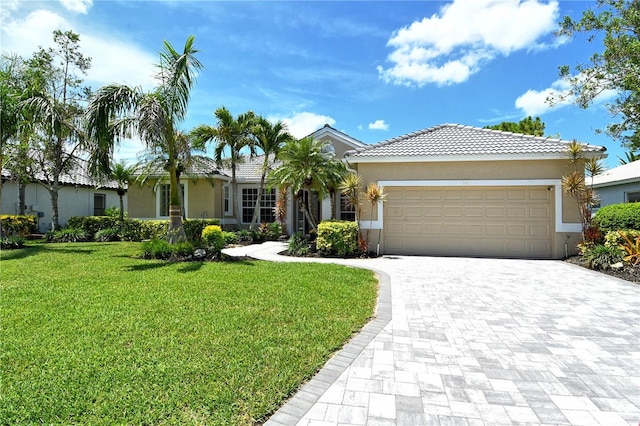 5080 Timber Chase Way, Sarasota, FL 34238 - ranch-style home with an attached garage, decorative driveway, stucco siding, and a front lawn