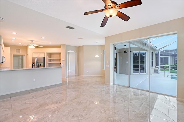5080 Timber Chase Way, Sarasota, FL 34238 - empty room featuring a ceiling fan, arched walkways, light marble finish floors, and recessed lighting