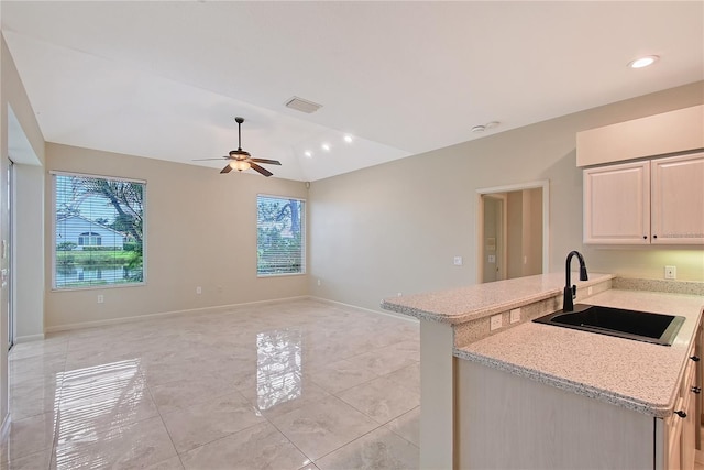 5080 Timber Chase Way, Sarasota, FL 34238 - kitchen with plenty of natural light, light tile patterned floors, a ceiling fan, a peninsula, and vaulted ceiling