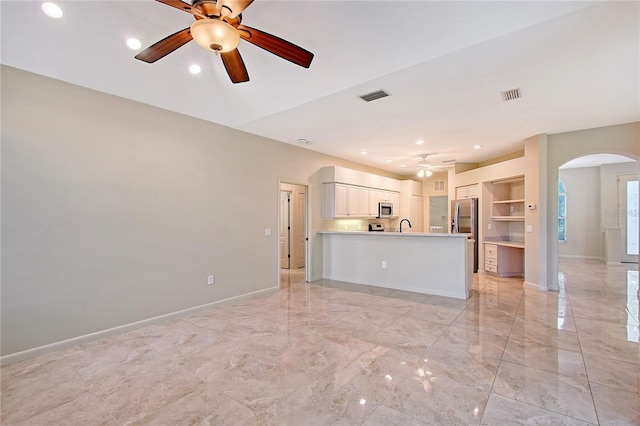 5080 Timber Chase Way, Sarasota, FL 34238 - unfurnished living room featuring a ceiling fan, arched walkways, light marble finish flooring, and recessed lighting