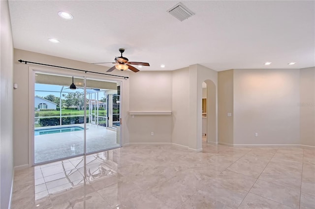 5080 Timber Chase Way, Sarasota, FL 34238 - spare room with arched walkways, a ceiling fan, recessed lighting, and a sunroom