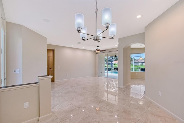 5080 Timber Chase Way, Sarasota, FL 34238 - unfurnished room featuring a ceiling fan, a chandelier, light marble finish flooring, arched walkways, and recessed lighting